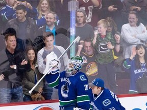 Jacob Markstrom (right) helps then-Canucks goalie Eddie Lack celebrate a shootout win over the L.A. Kings last April.