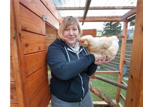 Jaydeen Williams holds one of the chickens she keeps in her backyard. ‘Everyone loves them,’ she says.   Arlen Redekop/PNG