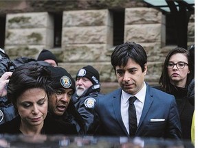 Jian Ghomeshi leaves court in Toronto on Thursday with his lawyer, Marie Henein, after being acquitted of sex crimes.