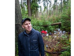 Jonathan Weissman surveys a pile of trash in Stanley Park.   Ric Ernst/PNG