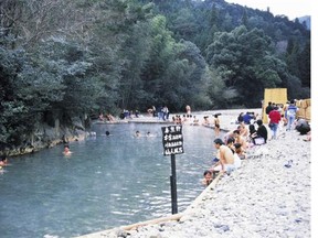 The Kawayu onsen is a hot spring in a river where men, women and children can bathe together, wearing special bathing robes.  Japan National Tourism Organization