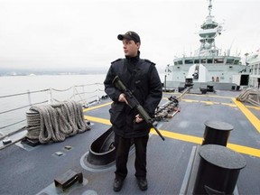 Leading seaman Matthew Pitts of Chilliwack stands guard on board HMCS Vancouver as it’s docked in its namesake city Thursday. HMCS Vancouver recently completed its Halifax Class life extension. — THE CANADIAN PRESS