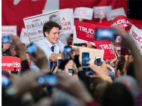 Liberal leader Justin Trudeau greets supporters as he takes the stage Sunday, October 18, 2015 in North Vancouver.