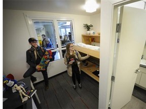 UBC students Micah Berlow (left) and Sydney Francis check out the tiny "full-scale" mock-up a news 140-square-foot student housing unit is on display for students this afternoon in the UBC Nest.