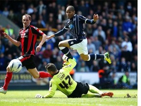 LONDON, ENGLAND - MAY 03: Simeon Jackson of Millwall goes close to goal as he avoids a clash with Bournemouth goal keeper Lee Camp during the Sky Bet Championship match between Millwall and Bournemouth at The Den on May 03, 2014 in London, England. (Photo by Charlie Crowhurst/Getty Images)