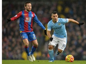 Manchester City's Sergio Aguero (R) runs with the ball from Crystal Palace's Yohan Cabaye during the English Premier League match at the Etihad Stadium in Manchester on Jan. 16, 2016.