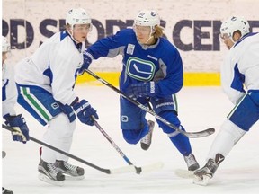 Markus Granlund, centre, practises Tuesday with the Canucks for the first time since being traded from the Calgary Flames Monday.