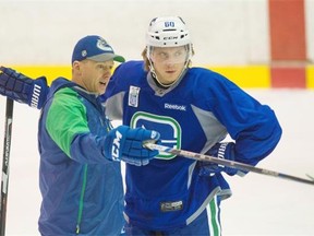 Markus Granlund gets some pointers from assistant coach Glen Gulutzan at practice at UBC with the Canucks on Tuesday, his first session with the team since being traded from the Calgary Flames earlier this week.