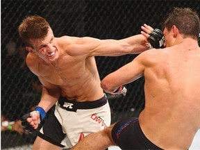 Matt Dwyer, left, punches Alan Jouban in their welterweight bout during the UFC event at the Valley View Casino Center last July in San Diego.