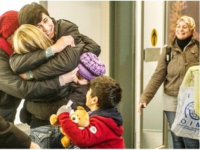 Members of the Kurdi family, refugees from Syria, arrive at Vancouver International Airport on Dec. 28. The extended family of Alan Kurdi, who died trying to cross the Mediterranean, will take in a UBC varsity hockey game on Friday.