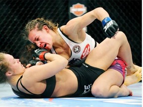 Miesha Tate, top, of Yakima, Wash., punches to Ronda Rousey during UFC 168 in 2013, which Rousey won.