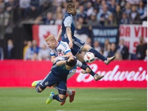 Montreal Impact’s Calum Mallace, centre, collides with Vancouver Whitecaps’ Jordan Harvey, top, and Masato Kudo during the second half of last Sunday’s game at B.C. Place. The Whitecaps lost 3-2.