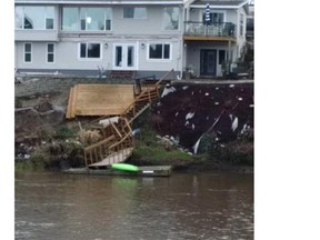 A home on the Esquimalt waterfront sits precariously after most of its yard and deck were washed away during recent heavy rains.