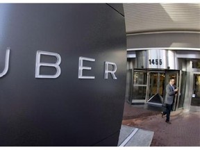 A man leaves the headquarters of Uber in San Francisco on Dec. 16, 2014. Late last month Edmonton became the first jurisdiction pass a new bylaw legalizing ride-sharing companies such as Uber. Experts say other cities are bound to follow. THE CANADIAN PRESS/AP, Eric Risberg