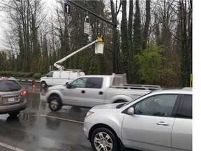 See that 'worker' in the bucket? He's an RCMP officer spotting drivers using their cellphones at Capilano Road and Marine Drive in North Vancouver on Wednesday.