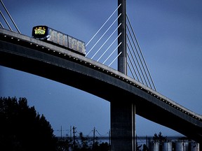 A Richmond-bound Canada Line train follows the chain of lights across the Fraser River bridge Sunday, Sept. 3, 2012,  in Vancouver, B.C.