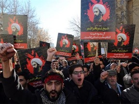 Iranian men hold portraits of prominent Shiite Muslim cleric Nimr al-Nimr during a demonstration against his execution by Saudi authorities, on January 3, 2016, outside the Saudi embassy in Tehran. Iran and Iraq's top Shiite leaders condemned Saudi Arabia's execution of Nimr, warning ahead of protests that the killing was an injustice that could have serious consequences.