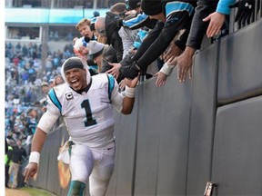 Cam Newton celebrates with fans at Charlotte’s Bank of America Stadium after the Panthers defeated the Seattle Seahawks 31-24 in the NFC divisional playoff game on Sunday.   — Getty Images