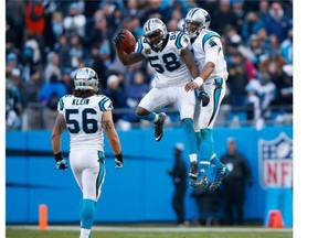 Cam Newton and Thomas Davis of the Carolina Panthers go airborne to celebrate after defeating the Seattle Seahawks 31-24 in the NFC Divisional Playoff Game on Sunday.   — Getty Images