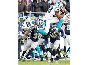 Panthers linebacker Thomas Davis leaps to receive an on-side kick late in the fourth quarter of Carolina’s 31-24 victory Sunday over the Seattle Seahawk.   — The Associated Press