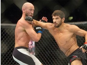 Patrick Cote, right, lands a punch on Josh Burkman during a UFC welterweight bout Aug. 23 in Saskatoon.