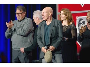 Sir Patrick Stewart, centre, sticks out his tongue in jest as he enters the stage during a reunion of the full cast of Star Trek: The Next Generation at Palais des Congrés in Montreal on Saturday during the second day of Comiccon, a weekend convention celebrating comic and movie characters. Stewart played Captain Jean-Luc Picard in the series. Others on stage are, Jonathan Frakes — Commander Riker, left, Brent Spiner — Data, second left, Gates McFadden — Doctor Crusher, Levar Burton — Geordi La Forge and Marina Sirtis — Deanna Troi, right. About 40,000 fans are expected for the event that runs from Sept. 12 to 14.