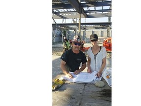 Paul Beacom, from Local 97 of the Ironworkers Union of B.C. and Caroline Hart, of Builders Without Borders, examine blueprints on the site of the rebuilt school.   — Caroline Hart