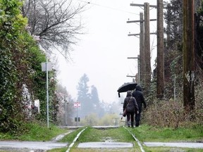 Pedestrians walk along the Arbutus corridor Monday as the City of Vancouver and CP Rail have reached a deal over the land — $55 million for the strip from Milton Street near the Fraser River to 1st Avenue near False Creek. Nick Procaylo/PNG