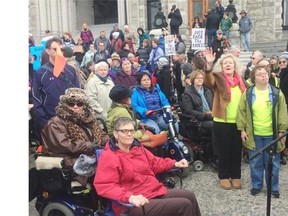 People take part in a protest Wednesday in Victoria against the B.C. government’s refusal to pay for bus passes for the disabled.   — The Canadian Press