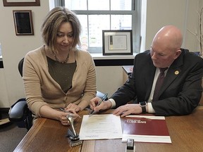 Notary David Watts helps out Adrienne Voute in making a will. Notaries urge everyone not to hold off on the important document to ensure your wishes are carried out.