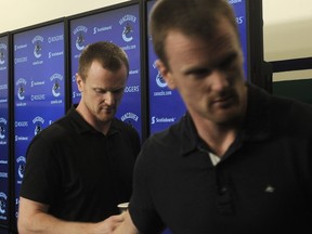 The Sedins leave the stage after talking to media as the Vancouver Canucks wrap up their unsuccessful season in Vancouver, BC., April 11, 2016.