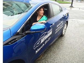 Premier Christy Clark rolls up to a press conference Wednesday in Vancouver behind the wheel of an electric car. Clark announced that all electric vehicles displaying a provincially issued decal will be permitted to use HOV lanes throughout B.C. regardless of the number of passengers in the car.