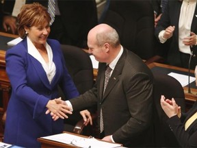 Premier Christy Clark shakes hands with Finance Minister Mike de Jong after he delivered the government’s budget speech Tuesday in the legislature.     — The Canadian Press