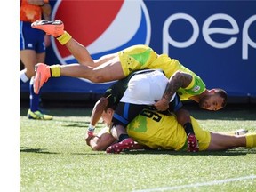 Quade Cooper, top, and Ed Jenkins, bottom, of Australia near the try line after Rosko Specman of South Africa, centre, was penalized for a high tackle on Jenkins during their semifinal on Day 2 of the Men’s 2016 USA Sevens Rugby Tournament match at the Sam Boyd Stadium in Las Vegas on March 6. — Getty Images files