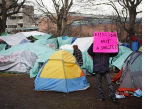 Residence of a homeless camp are shown in Victoria on Monday, January 11, 2016. Police in Victoria say they won't immediately enforce a Thursday deadline aimed at clearing residents from a tent encampment in the city's downtown core.