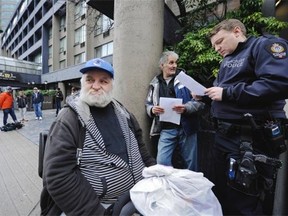 Robert Dal Passo, front, waits outside the Communinty Builders Foundation complex at 1335 Howe St. on Sunday with low-income housing advocate Dan Zimmermann, rear.    Mark van Manen/PNG