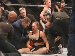 Ronda Rousey receives medical treatment after being knocked out by Holly Holm in their UFC women’s bantamweight championship bout at UFC 193 event Melbourne in November.