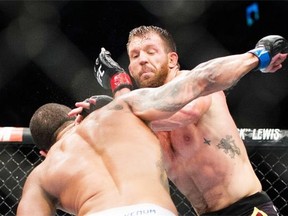 Ryan Bader, left, fights Rafael Feijao in a  light-heavyweight bout during UFC 174 at Rogers Arena in 2014.