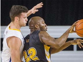 Ryerson’s Filip Vujadinovic, left guards Dalhousie’s Kashrell Lawrence during Sunday’s bronze medal game in the CIS men´s basketball championship Final 8 tournament at UBC.  Ryerson won 85-78.   Ric Ernst/PNG