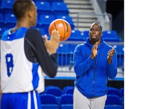 Ryerson Rams interim head coach Patrick Tatham, right, claps during the team’s practice before the Final 8 tournament at the Doug Mitchell centre Wednesday.