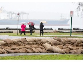 Sandbags are placed along the shores of Locarno Beach in Vancouver, Wednesday Dec. 10, 2014, to prepare for a previous king tide.