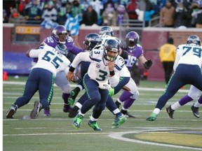 Seattle quarterback Russell Wilson chases down an errant snap on a key play in the Seahawks’ 10-9 victory Sunday at Minnesota.    — The Associated Press