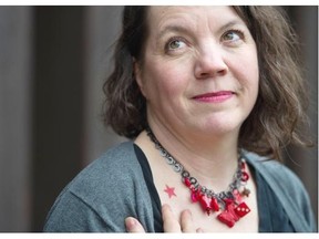 Sonja Larsen, who has written a memoir, Red Star Tattoo — My Life as a Girl Revolutionary, shows her tattoo and a necklace of red items she has collected on Thursday in Vancouver.
