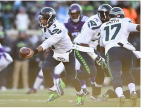 Russell Wilson #3 of the Seattle Seahawks hands the ball off in the second half against the Minnesota Vikings during the NFC Wild Card Playoff game at TCFBank Stadium on January 10, 2016 in Minneapolis, Minnesota.