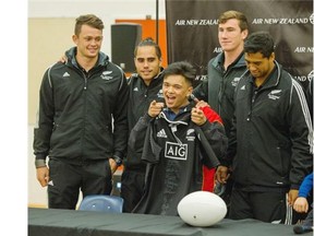 Grade 12 Tupper student, and rugby player, Kyle Talingdan has his photo taken with All Blacks Seven Squad members, left to right, Lewis Ormond, Beadein Waaka, Sam Dickson and Regan Ware during a visit from the New Zealand Rugby Club at Sir Charles Tupper Secondary in Vancouver on Wednesday. Arlen Redekop/PNG