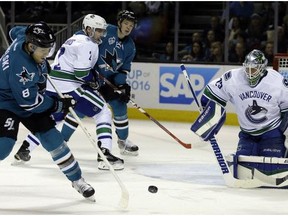Joe Pavelski takes a shot against Canucks goalie Jacob Markstrom, right, during the first period of an NHL hockey game Saturday, March 5, 2016, in San Jose, Calif.