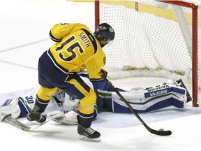 Nashville's Craig Smith pots the winning goal in a 3-2 shootout win over the Canucks on Thursday night.