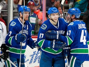 Sven Baertschi #47 and Daniel Sedin #22 congratulate Radim Vrbata #17 of the Vancouver Canucks in front of Blake Comeau #14 of the Colorado Avalanche during their NHL game at Rogers Arena February 21, 2016 in Vancouver, British Columbia, Canada.