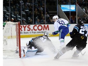 Daniel Sedin celebrates his goal, the first of the game, with Jannik Hansen on Thursday night at the SAP Center.
