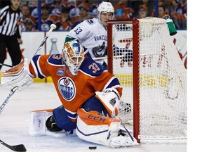 Goaltender Cam Talbot of the Edmonton Oilers makes a save on Bo Horvat #53 of the Vancouver Canucks on April 6, 2016 at Rexall Place in Edmonton, Alberta, Canada.